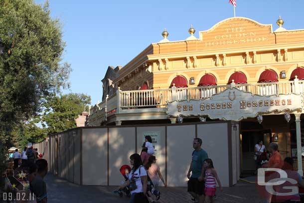 Walls extend down the left side walkway (the wood boardwalk) from the Golden Horseshoe through Frontierland.