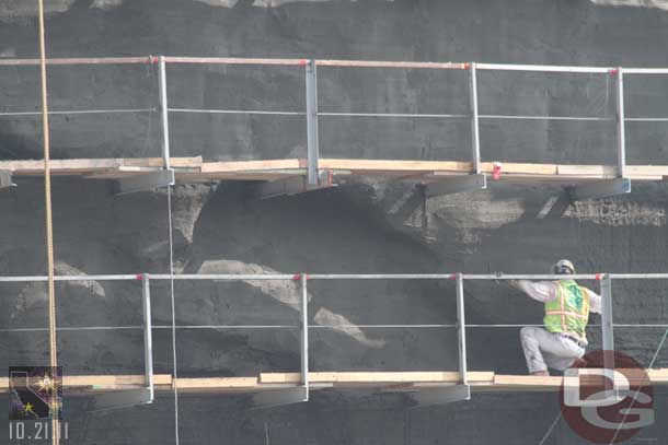 A closer look at a worker creating the face.