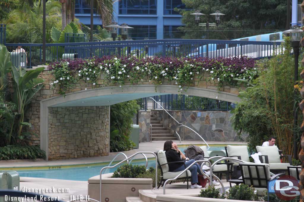 A couple guests hanging out near the spa but no one in the water.