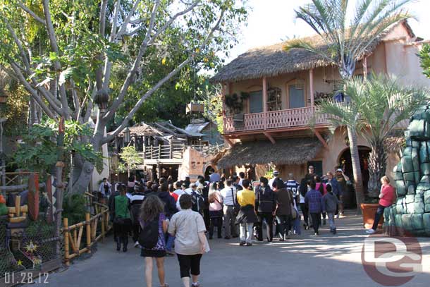 A large tour group heading into Adventureland.