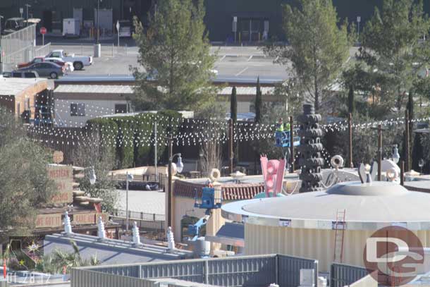 A crew working on the lights over the Flying tires (notice the lift).