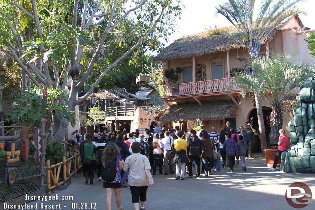 A large tour group heading into Adventureland.