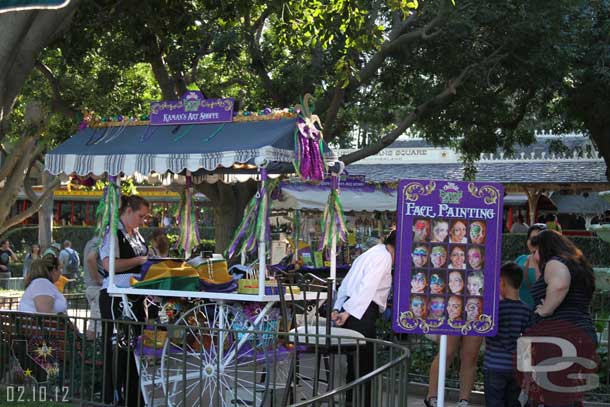 A face painting area set up near the fountain.