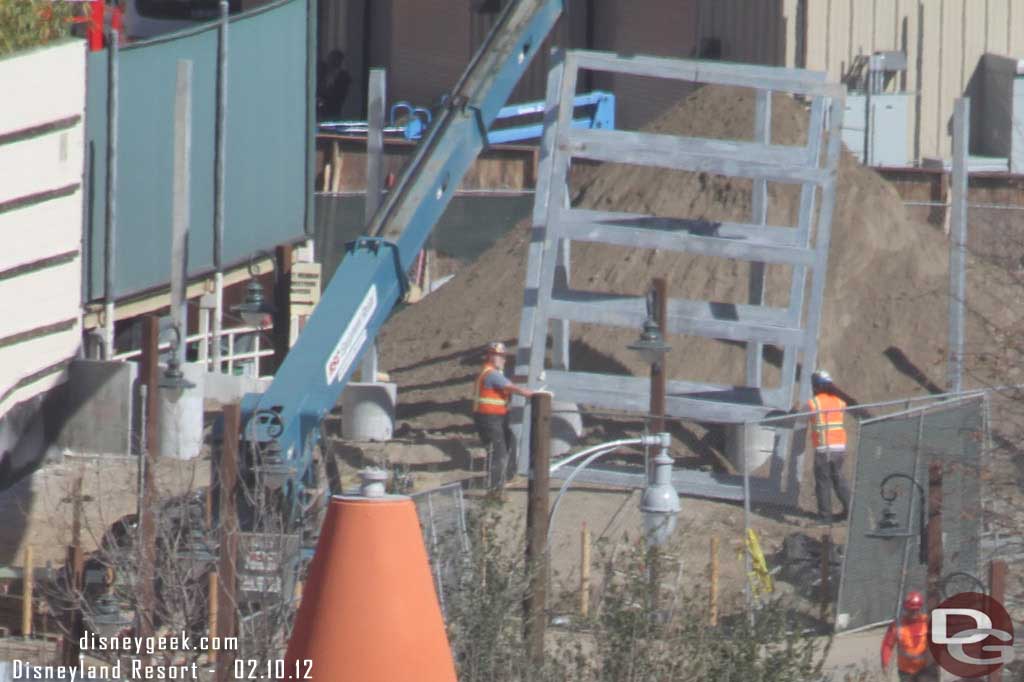 Looks like they are moving the gate/fencing around in the background.