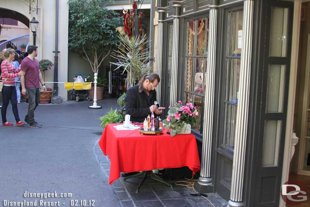 An artist working on perfume bottles.