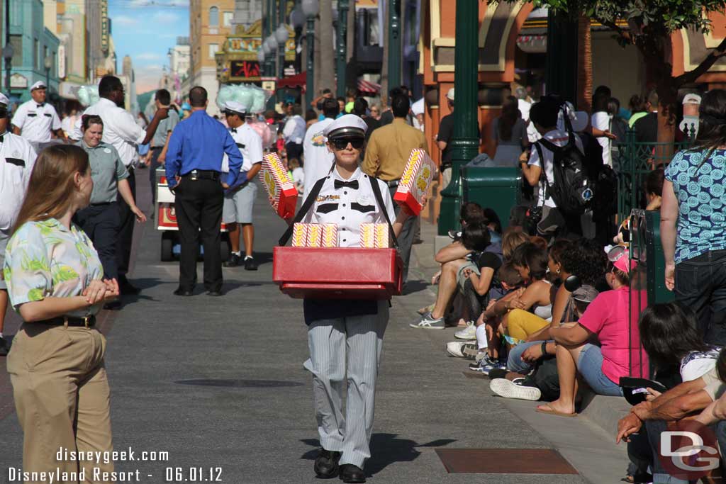 A vendor selling pop corn while you wait for the parade.