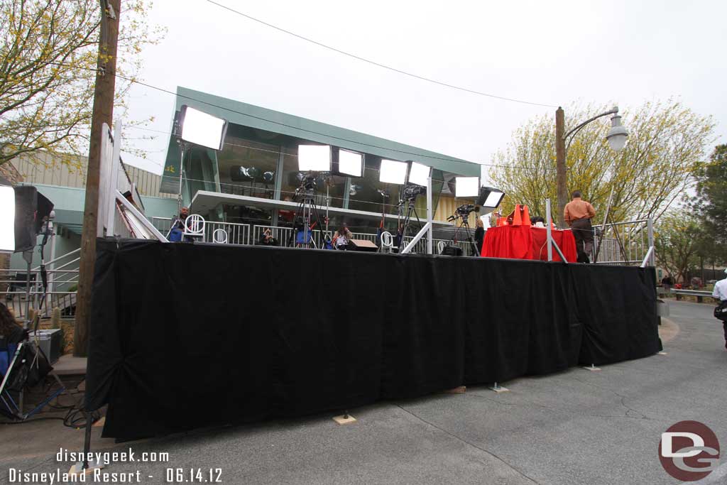 A platform set up for the media with Flos behind.  