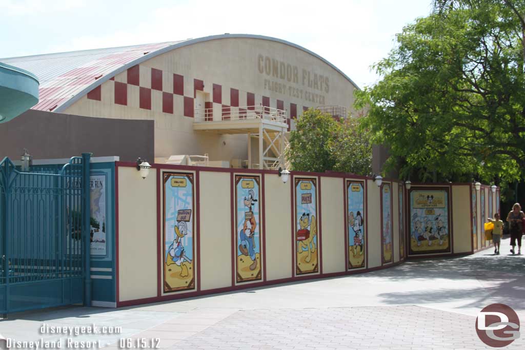 Walls up around the old temporary entrance area as they close it up and add a planter to match the other side.