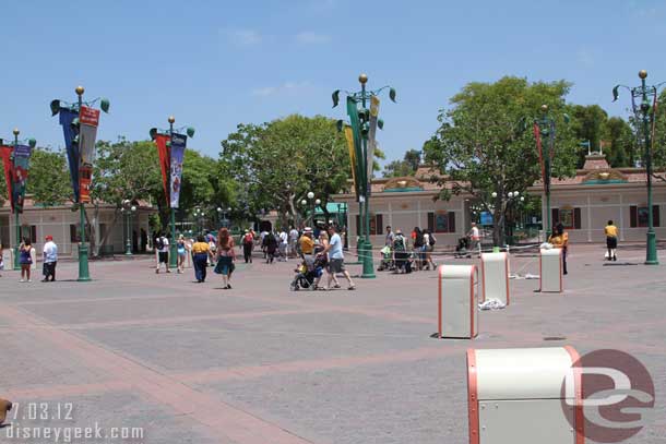 Cast members adjusting some sort of queue/ropes.  Not sure if they were cleaning up or setting up.