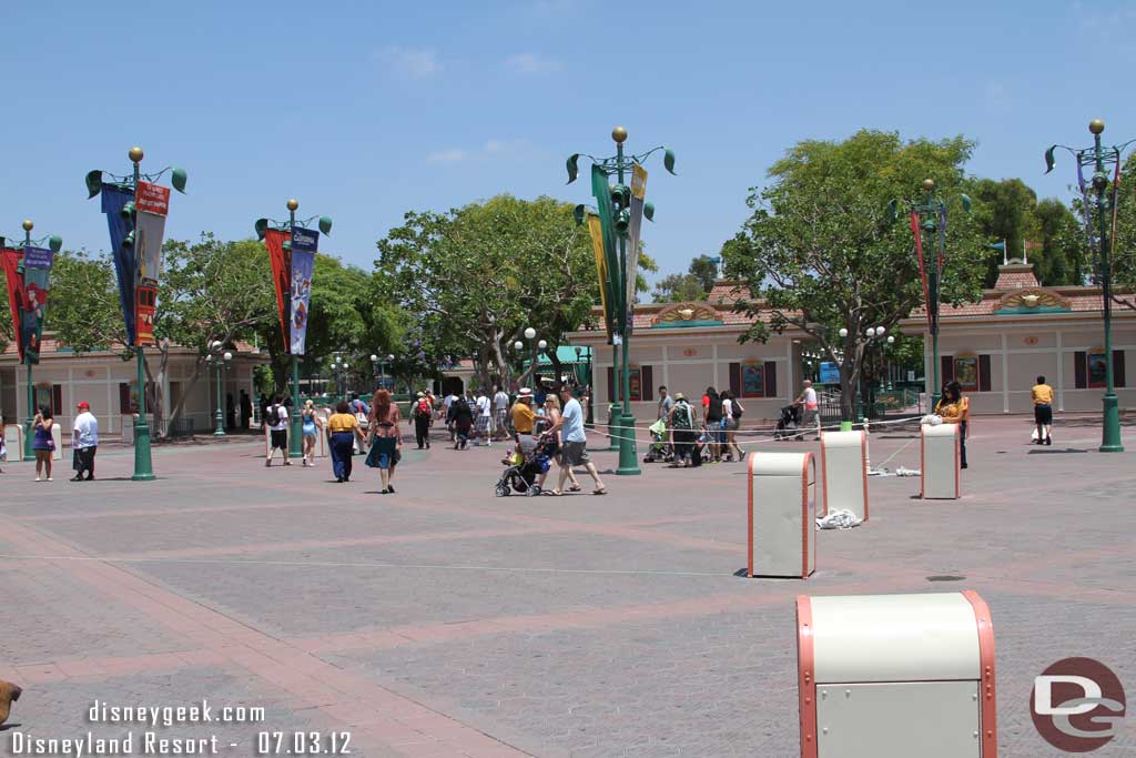 Cast members adjusting some sort of queue/ropes.  Not sure if they were cleaning up or setting up.