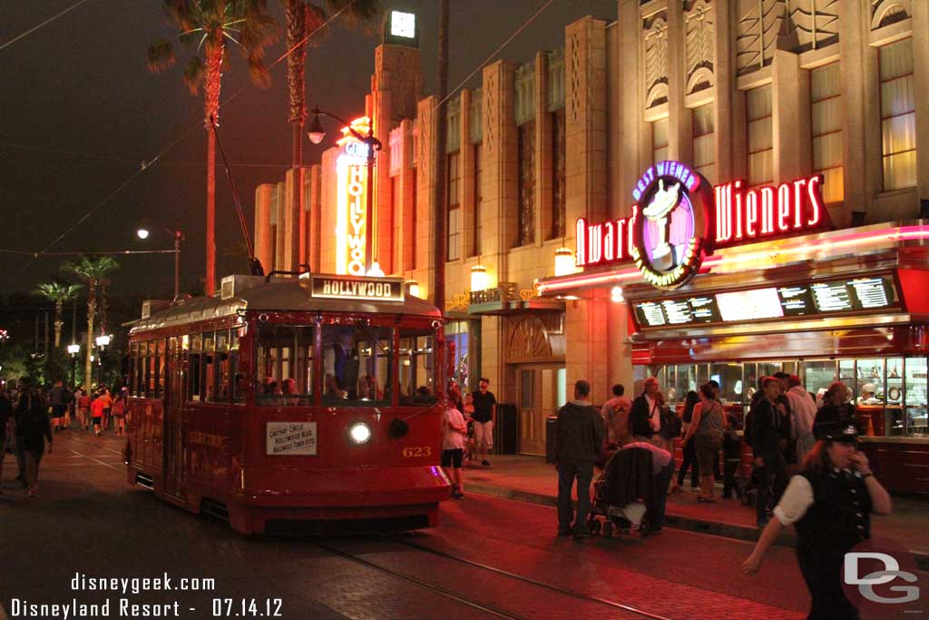 A Red Car making its way down Hollywood Blvd.