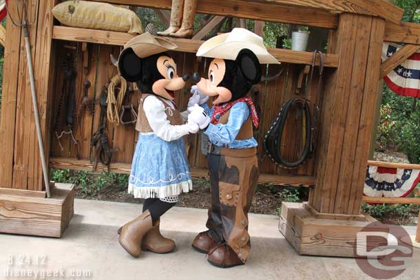 Mickey and Minnie posing for a picture.