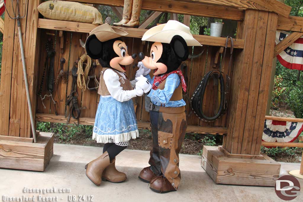 Mickey and Minnie posing for a picture.