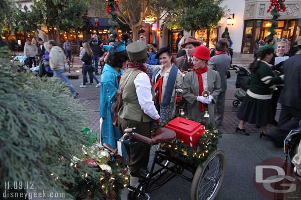 The Bell Ringers and other Citizens did gather near the tree.