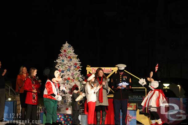 The star is passed to Mark Plummer to place on the tree.