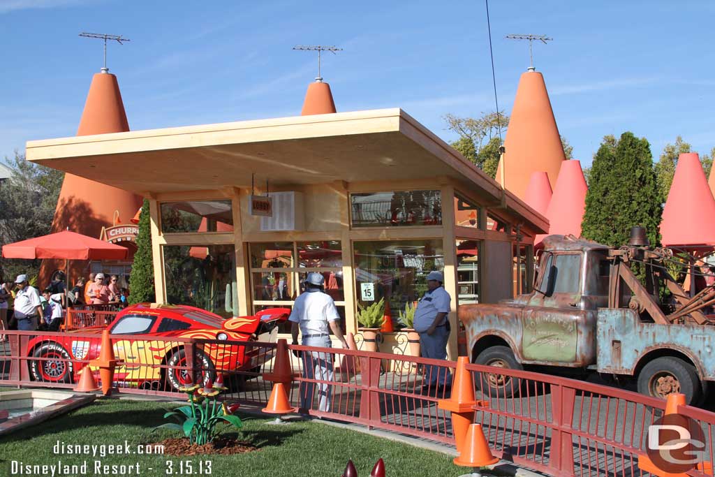 A traffic jam at the Cozy Cone as Lightening wraps up his pictures and Mater waits to take over.
