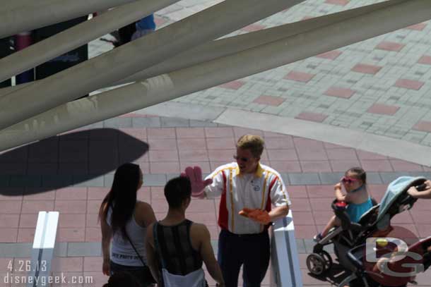 At the bottom of the escalator at the Mickey and Friends Garage a CM was giving everyone high fours!