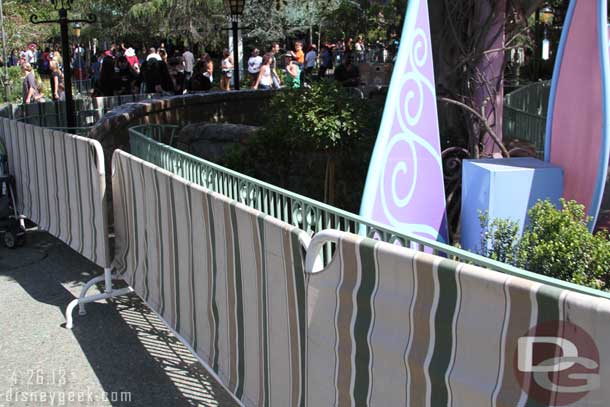 Painting the railing near the Mad Tea Party.