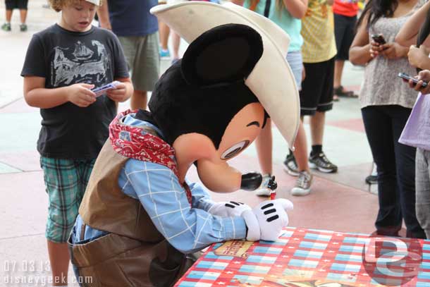 Cowboy Mickey pulled up a seat to sign autographs.