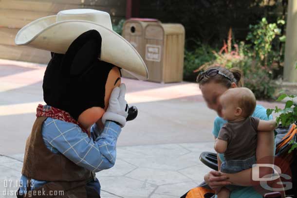 Mickey playing peek a boo with a child.