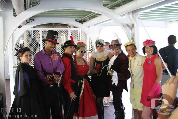 A group of Dapper Day guests posing for pictures on the lower deck.