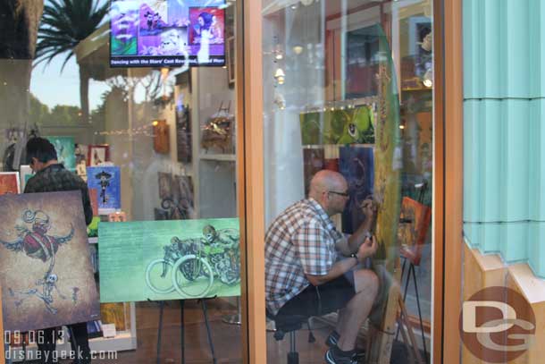 An artist working on a surf board