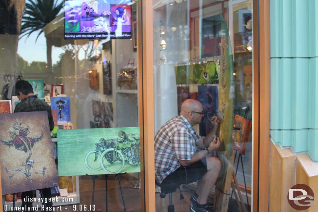 An artist working on a surf board