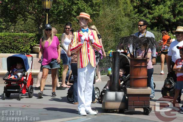 Bert in front of the castle performing with Mary and the Pearly Band.