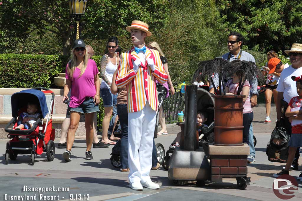 Bert in front of the castle performing with Mary and the Pearly Band.