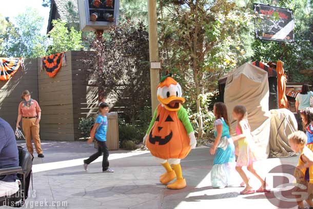 Donald playing follow the leader with a group of kids.