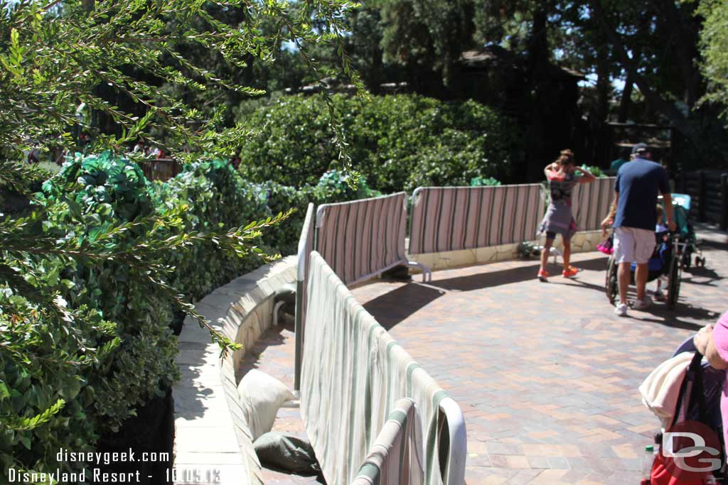 The walls are down on the walkway, but barriers still up.  Looks like the wall was redone.