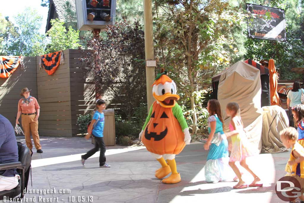 Donald playing follow the leader with a group of kids.