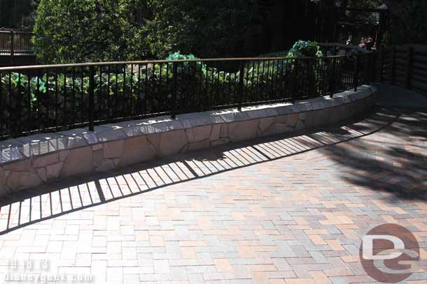 A railing has been added on top of the new wall on the trail to Frontierland.  I was disappointed to see the seating/ledge is gone.  So it means no place to sit and relax anymore.