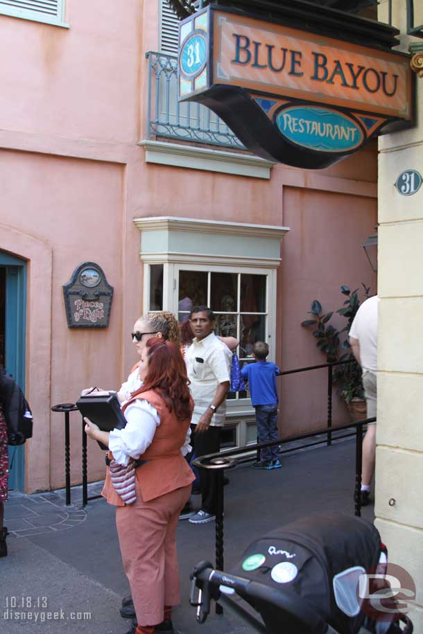 Cast Members by the exit of Pirates to issue return times to guests as part of the new disability access service.  