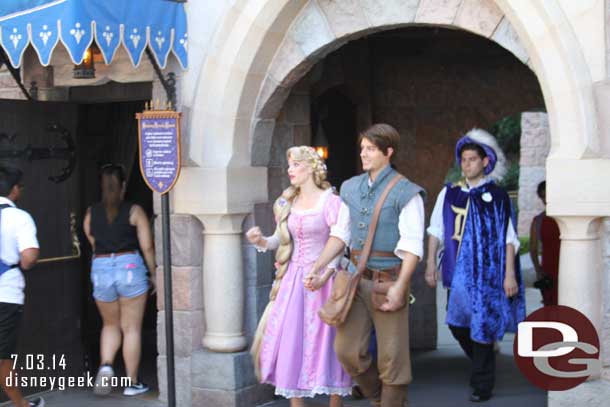 Rapunzel and Flynn Rider passing through Fantasyland.