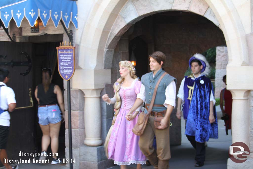 Rapunzel and Flynn Rider passing through Fantasyland.