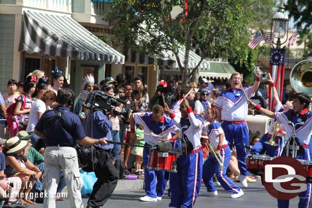 The band performing on Main Street USA.  Today a Disneyland film crew was recording their performances.