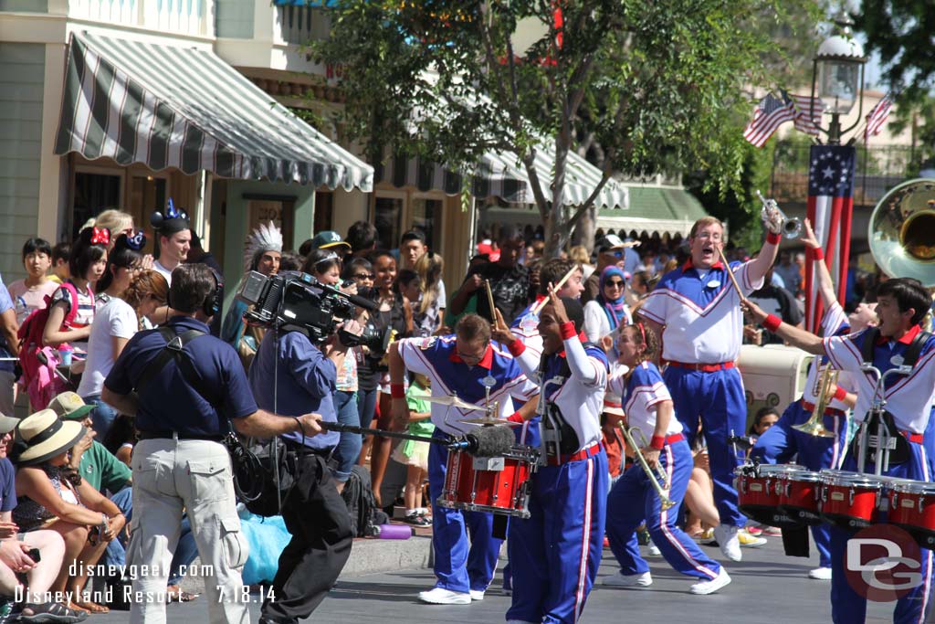 The band performing on Main Street USA.  Today a Disneyland film crew was recording their performances.