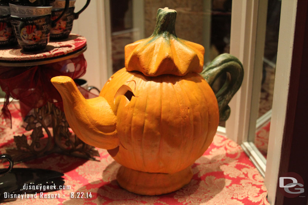 A pumpkin Mrs. Potts in the window.