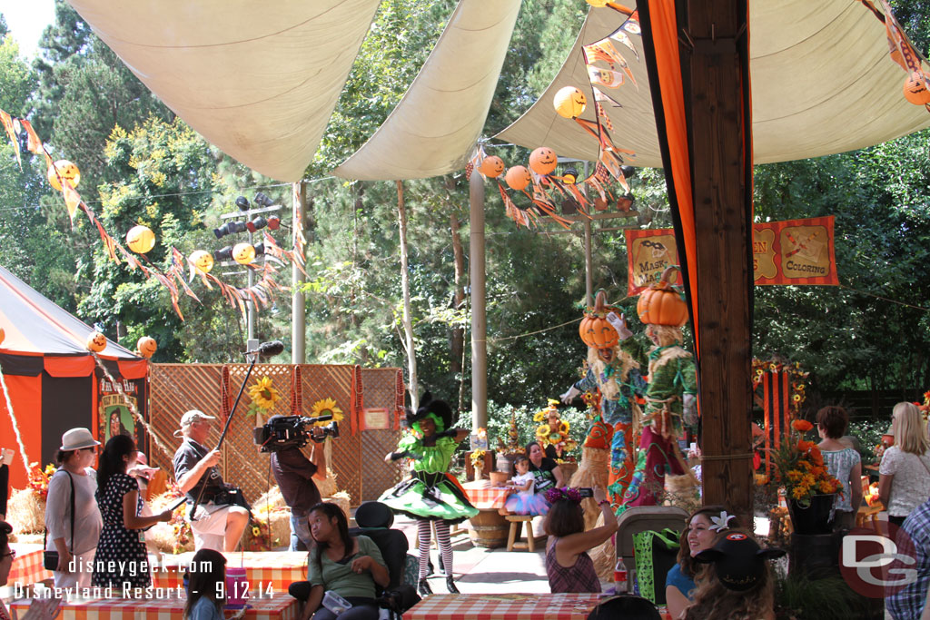 A couple of dancers lead the way then the stilt walkers.