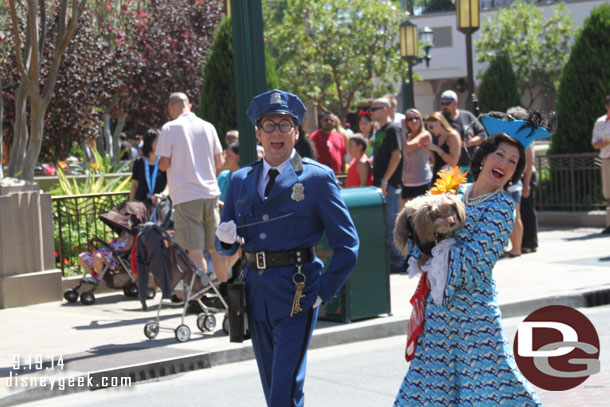 Officer Calvin Blue escorting Donna the Dog Lady down Buena Vista Street.