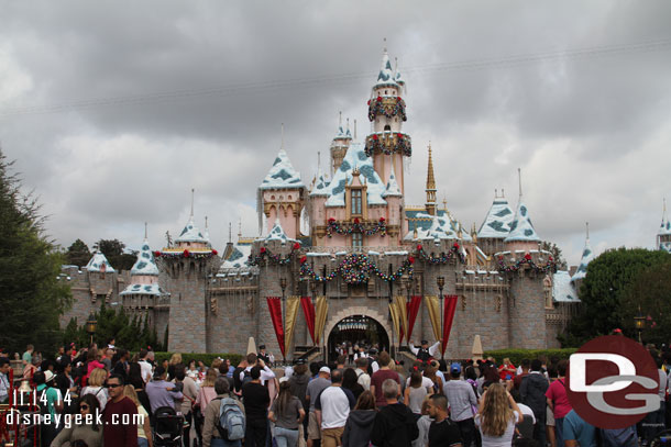 A crowd gathered for the Disneyland Band and character show in front of Sleeping Beauty Castle.