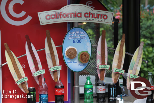 A cart selling churros of various flavors.