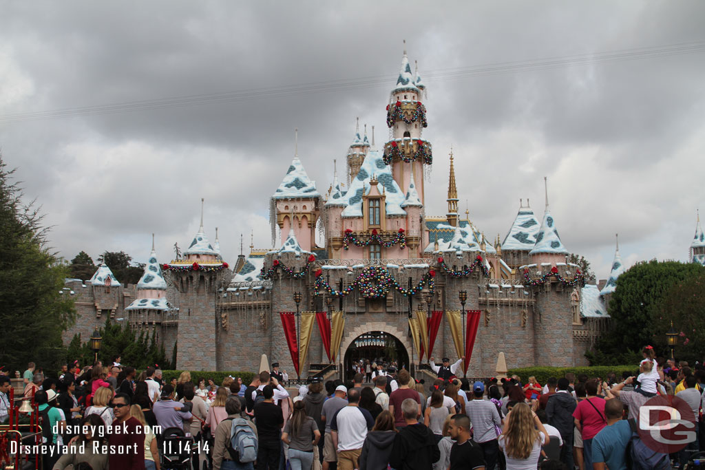 A crowd gathered for the Disneyland Band and character show in front of Sleeping Beauty Castle.