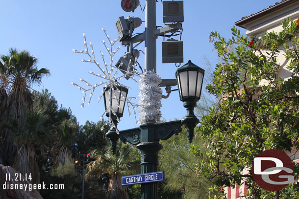 A minor tweak to the snow flake lights since last week.  More garland has been added to cover the supports/where it connects to the poles.