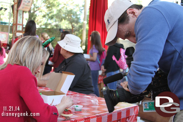 A reporter sat near by doing a segment on cookie decorating (mid show).  There was a media event going on with radio stations and others around the park for the holiday kickoff.