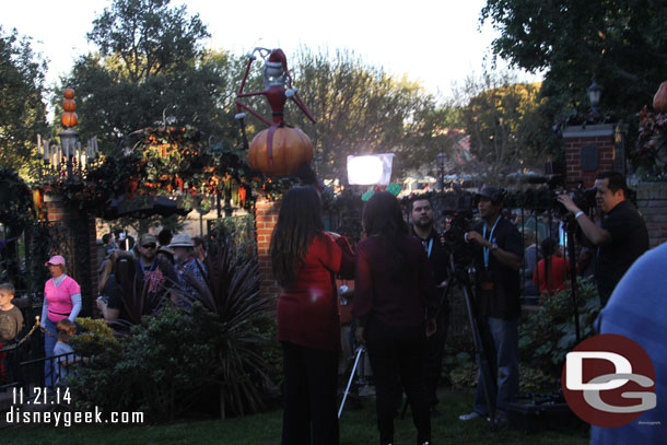 A film crew on the lawn of the Haunted Mansion