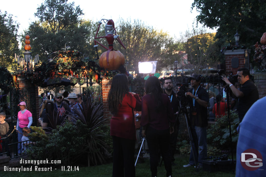 A film crew on the lawn of the Haunted Mansion