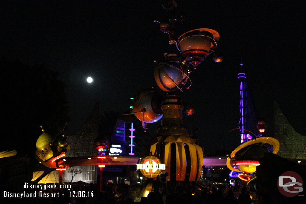 A full moon rising above Tomorrowland.