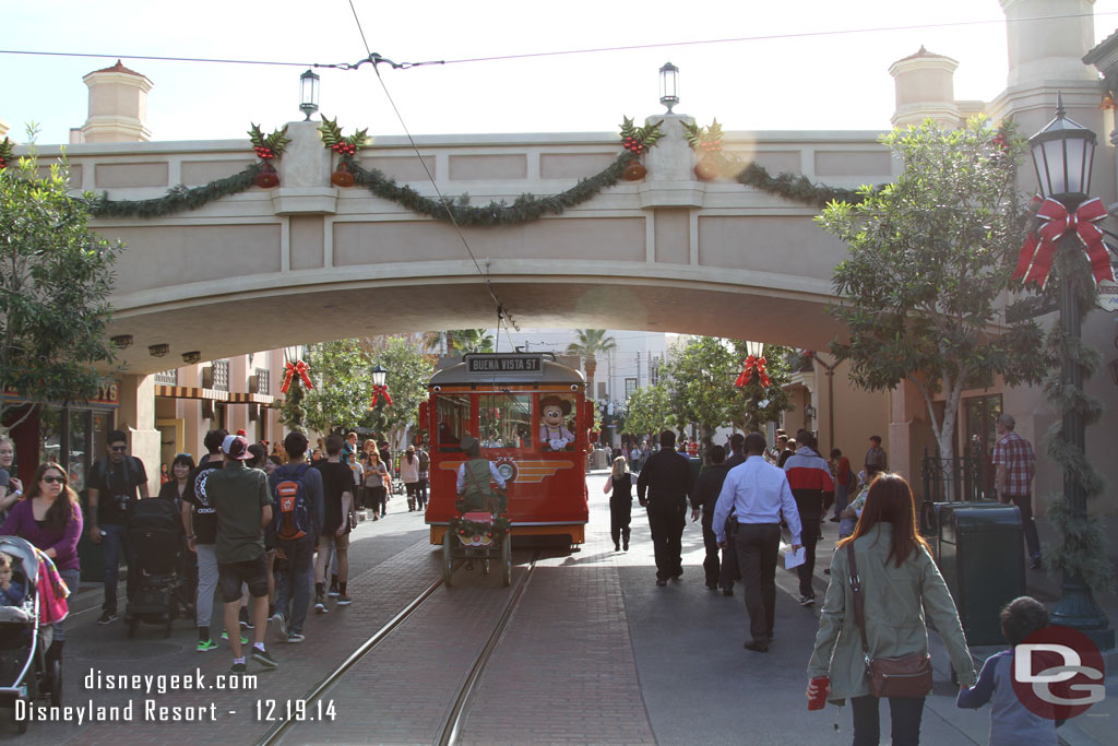 Mickey and the Red Car News Boys singing in a Red Car Trolley Sleigh as they travel on Buena Vista Street.